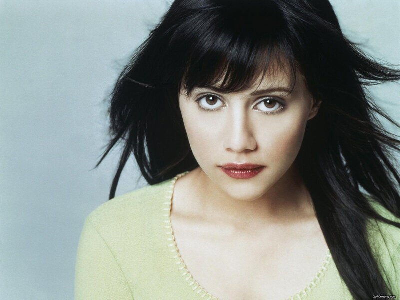 woman with dark hair in green sweater