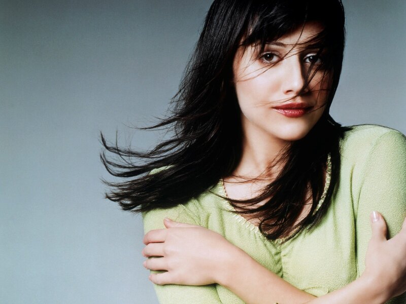 woman with dark hair in green top