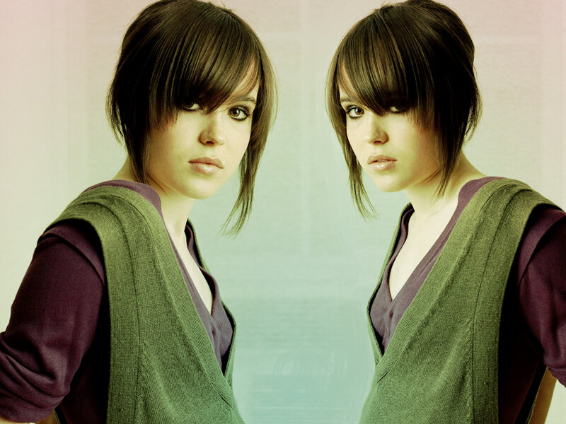 woman with dark hair in green vest
