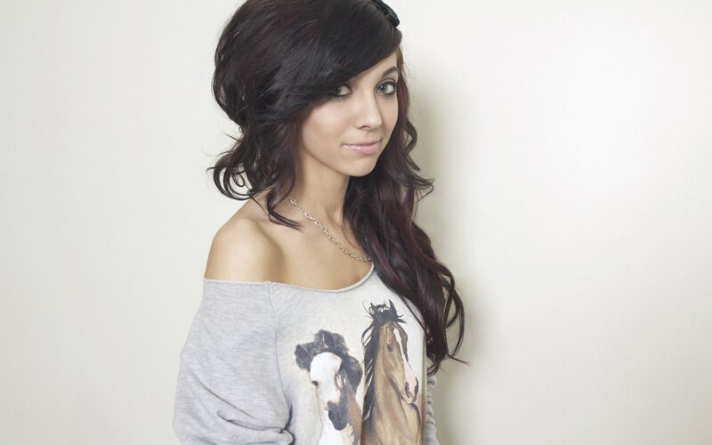 woman with dark hair in off-shoulder top