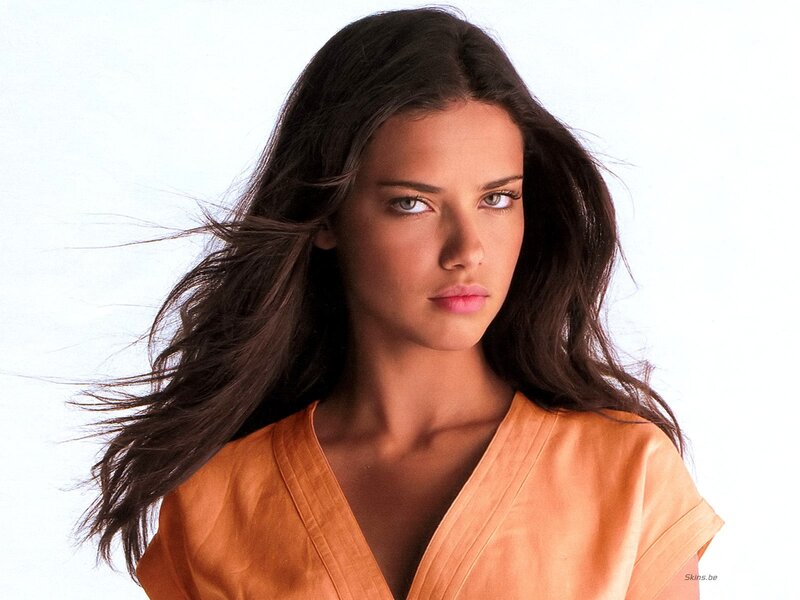 woman with dark hair in orange top