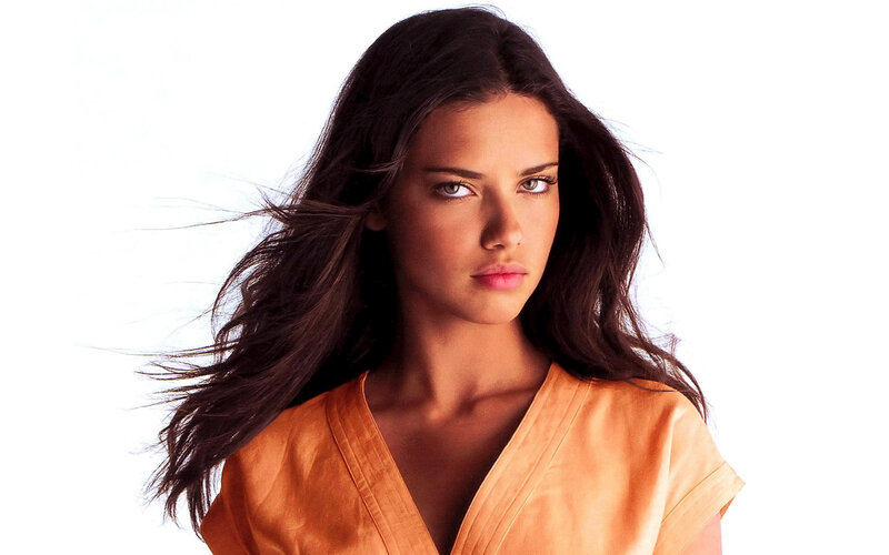 woman with dark hair in orange top