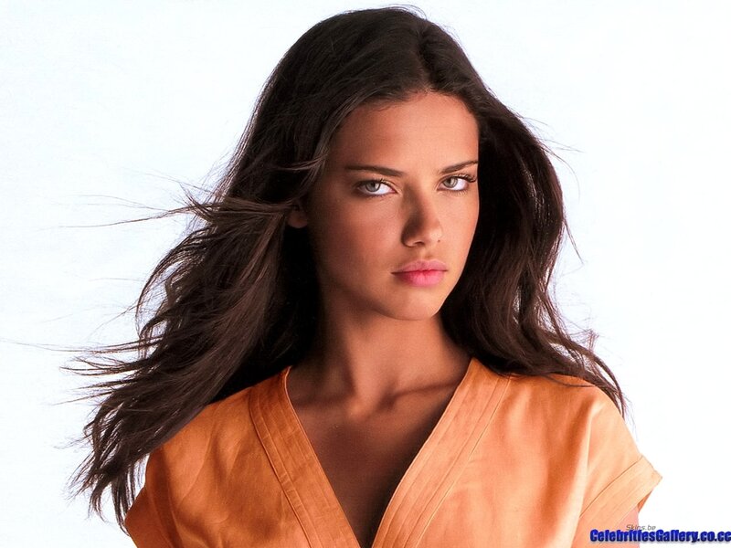 woman with dark hair in orange top