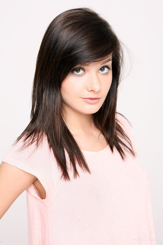 woman with dark hair in pink shirt