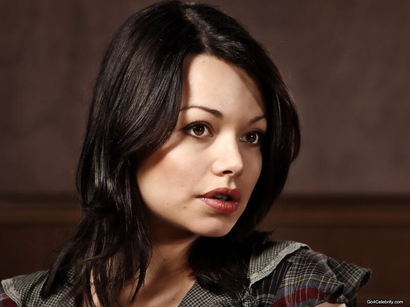 woman with dark hair in plaid shirt