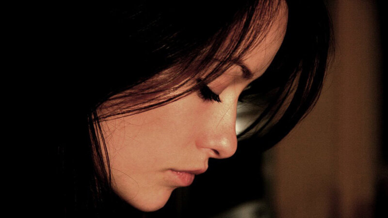 woman with dark hair in profile
