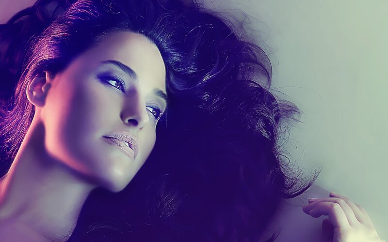 woman with dark hair in purple light