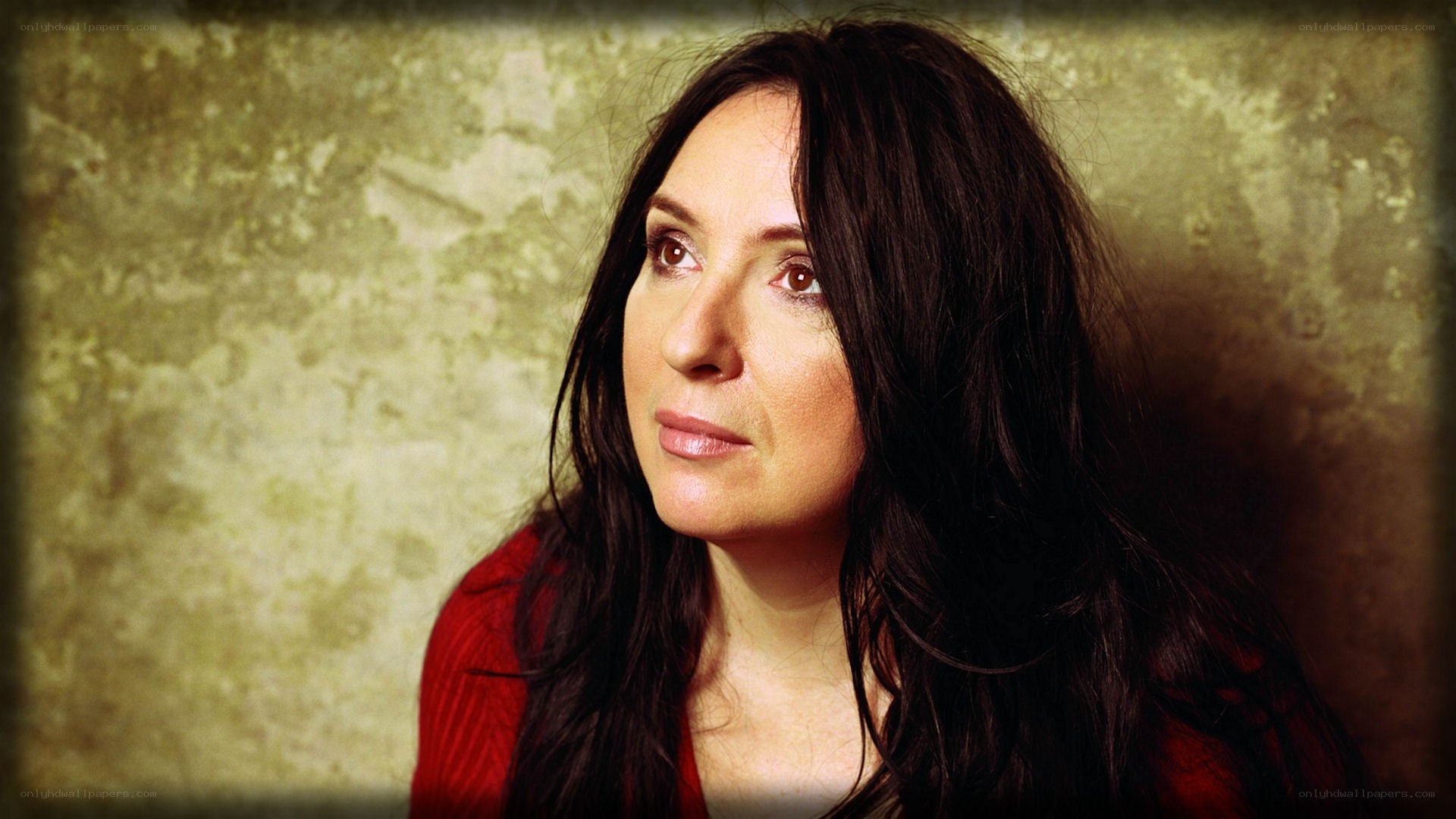 woman with dark hair in red top
