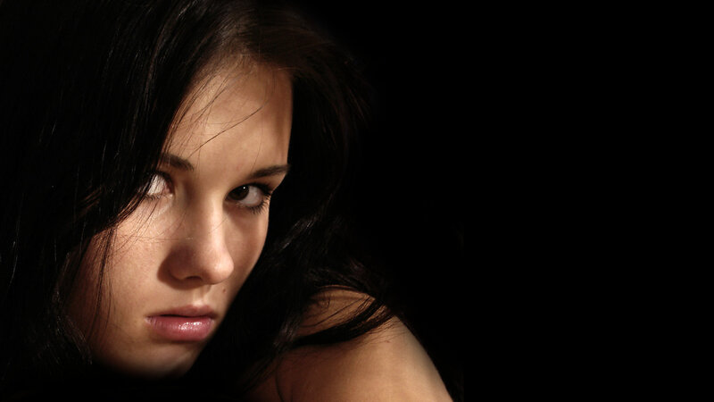 woman with dark hair in shadow