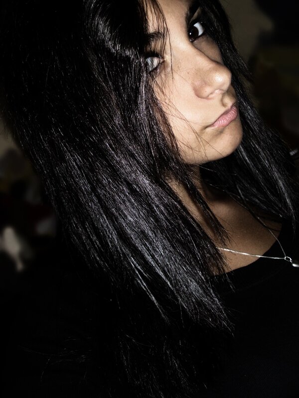 woman with dark hair in shadow