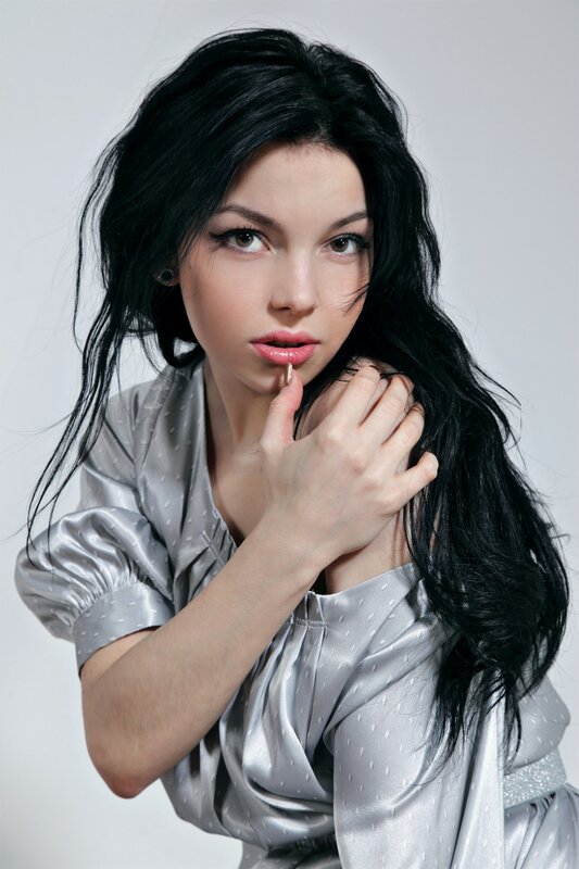 woman with dark hair in silver dress