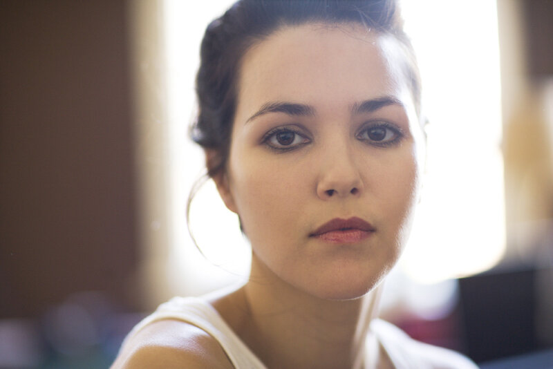 woman with dark hair in soft light