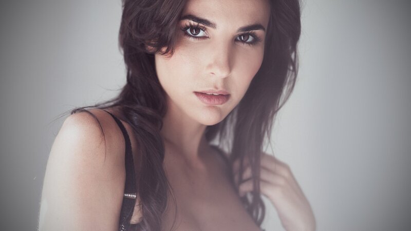 woman with dark hair in studio
