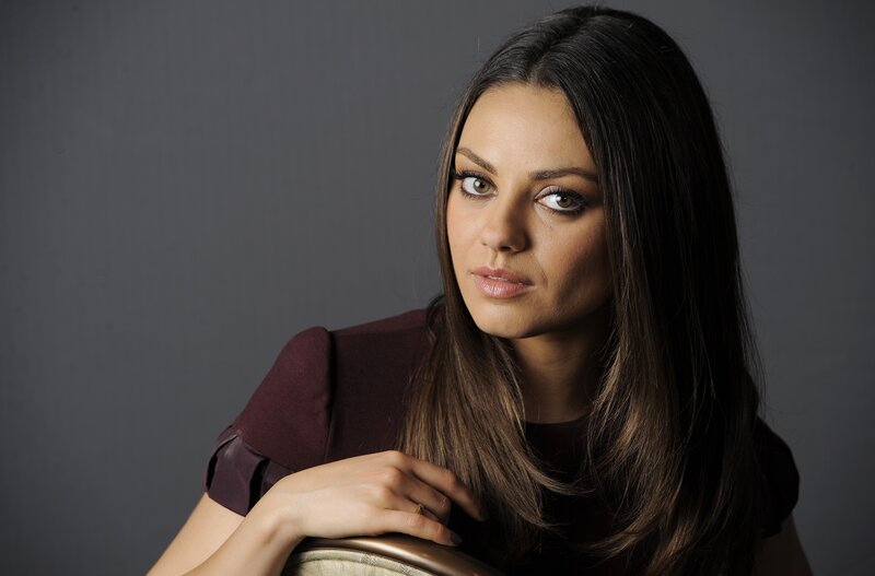 woman with dark hair in studio portrait