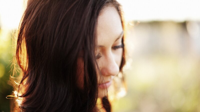 woman with dark hair in sunlight