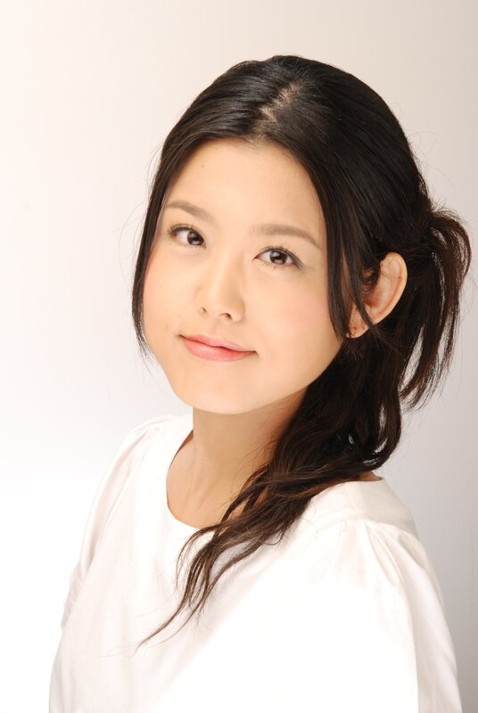 woman with dark hair in white shirt