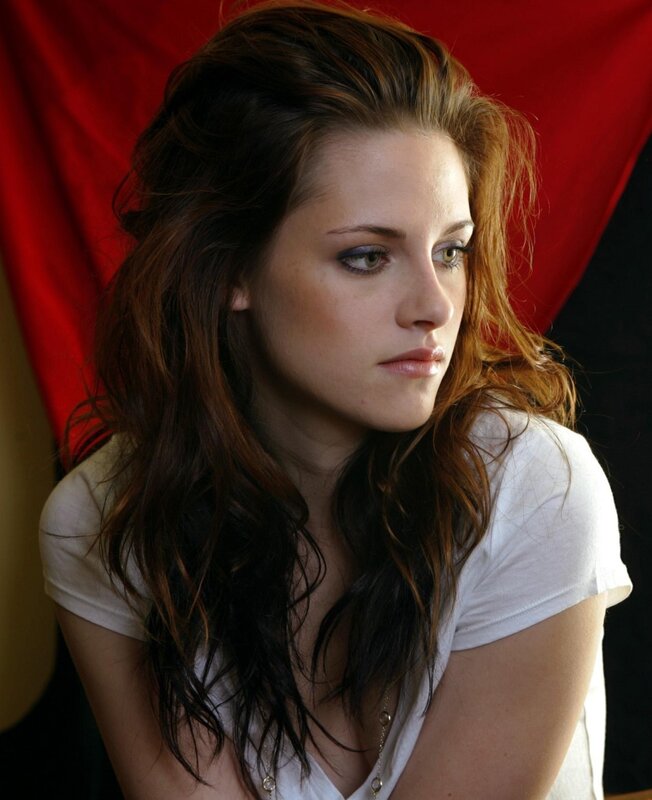 woman with dark hair in white shirt