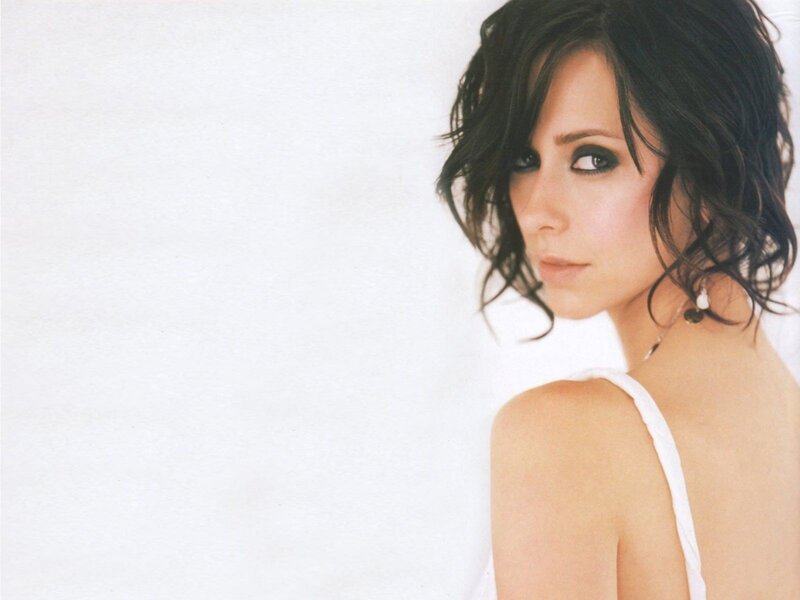 woman with dark hair in white top