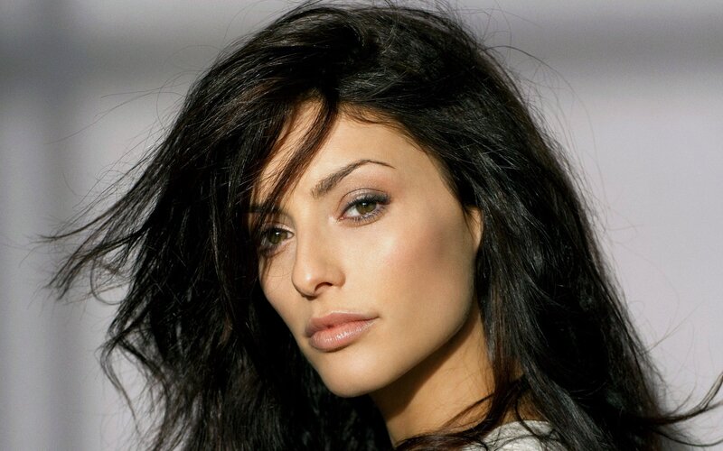 woman with dark hair looking at camera