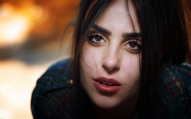 woman with dark hair looking at camera