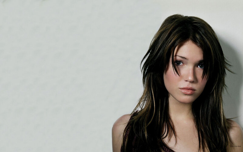 woman with dark hair looking at camera