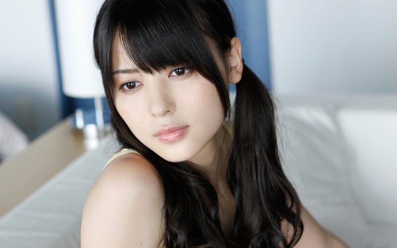 woman with dark hair looking at camera