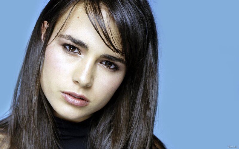 woman with dark hair looking at camera