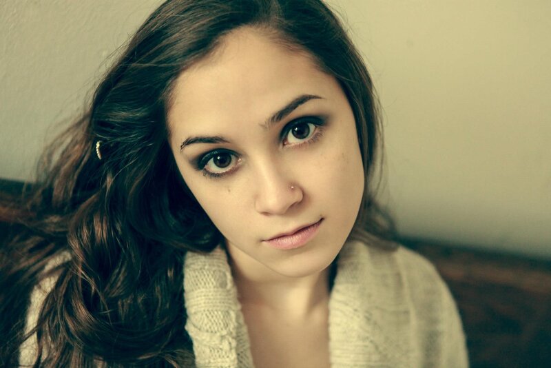 woman with dark hair looking at camera