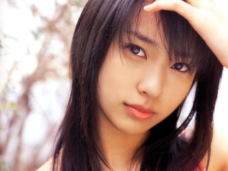 woman with dark hair looking at camera
