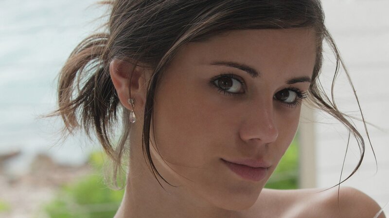 woman with dark hair looking at camera