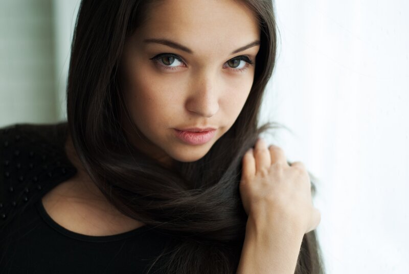 woman with dark hair looking at camera