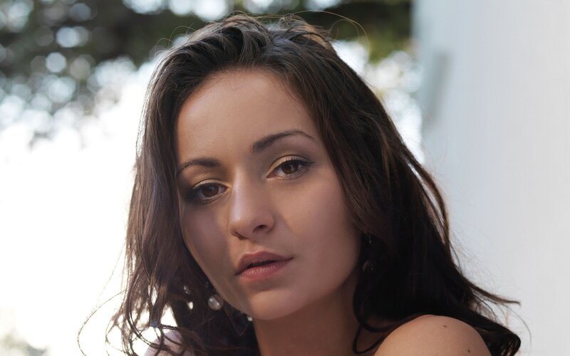 woman with dark hair looking at camera