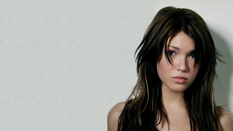 woman with dark hair looking at camera