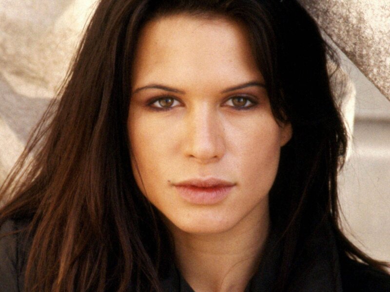 woman with dark hair looking at camera