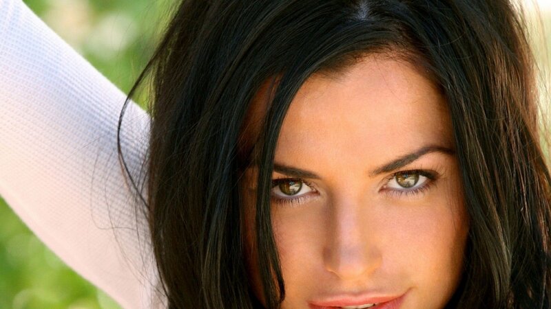 woman with dark hair looking at camera