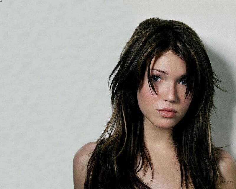 woman with dark hair looking at camera