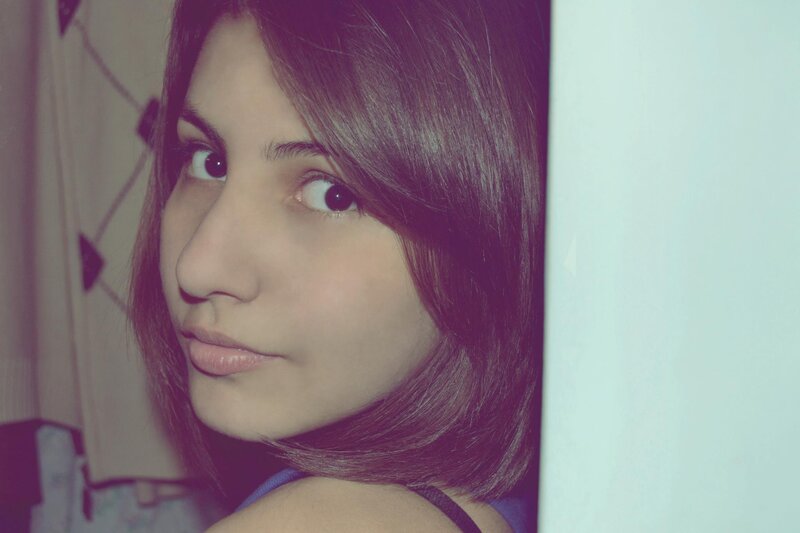 woman with dark hair looking at camera
