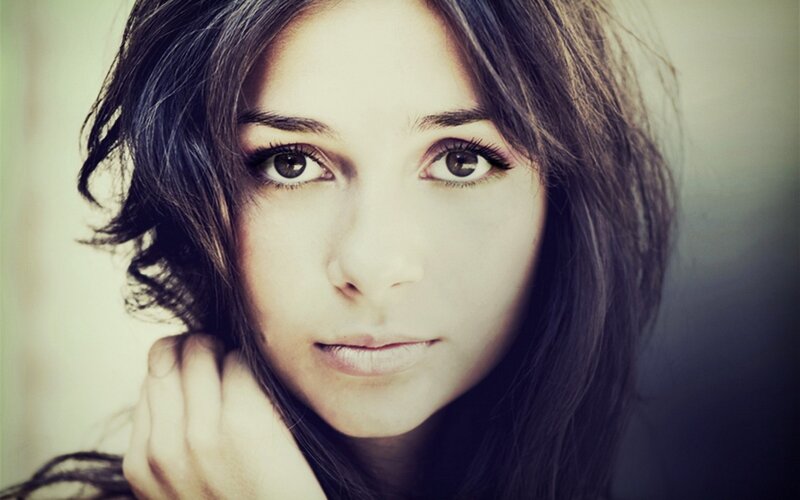 woman with dark hair looking at camera