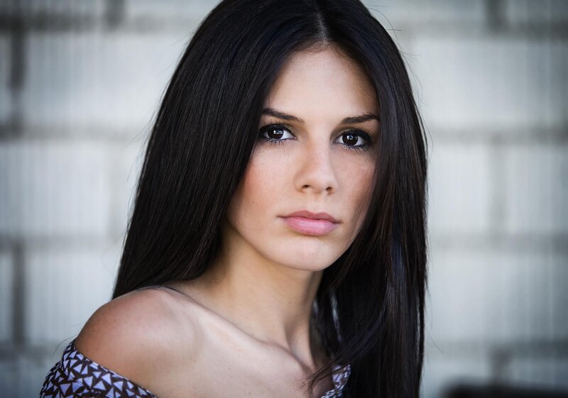 woman with dark hair looking at camera