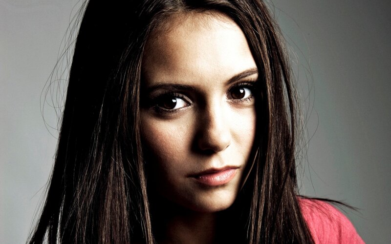 woman with dark hair looking at camera