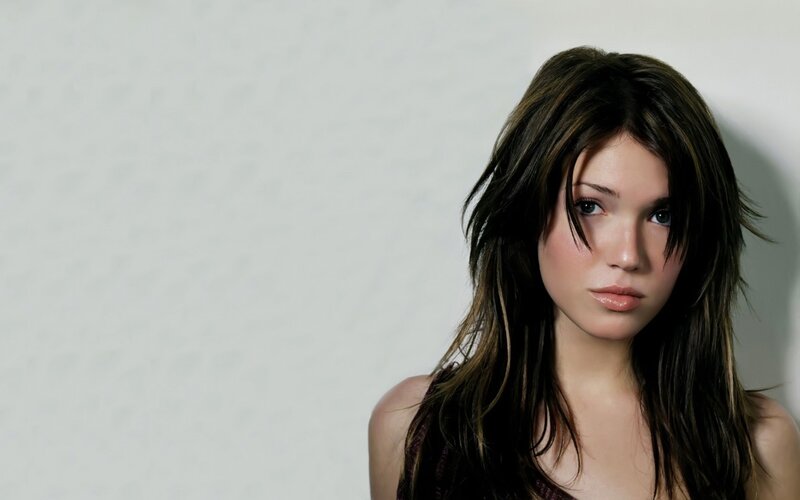 woman with dark hair looking at camera