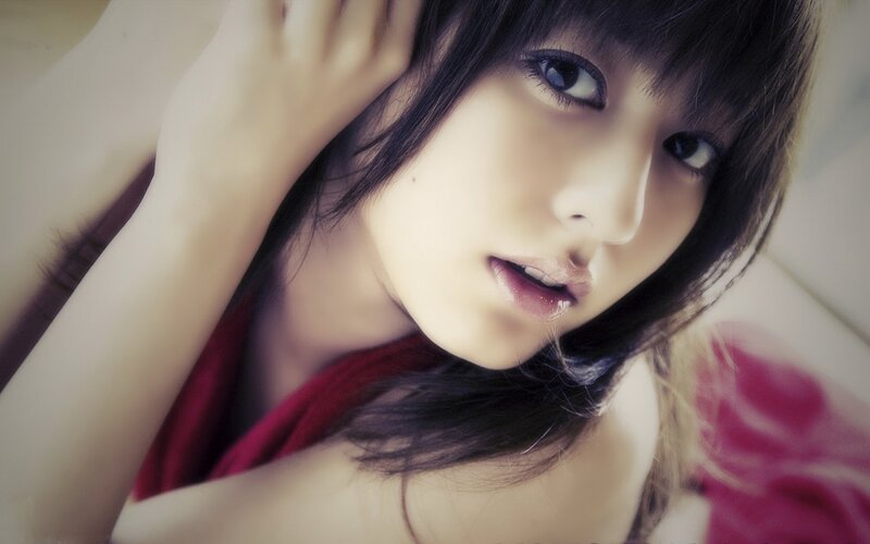 woman with dark hair looking at camera