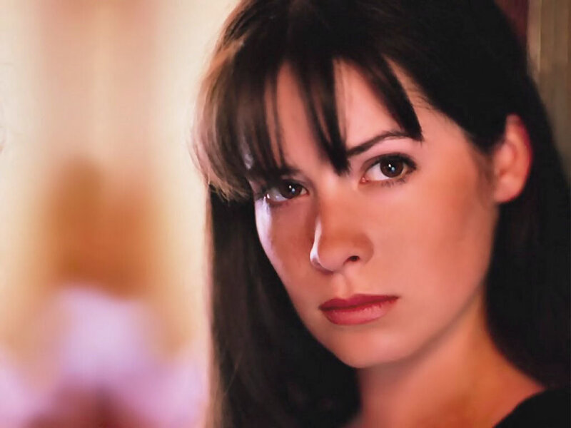 woman with dark hair looking at camera