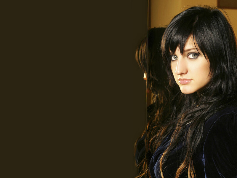 woman with dark hair looking at camera