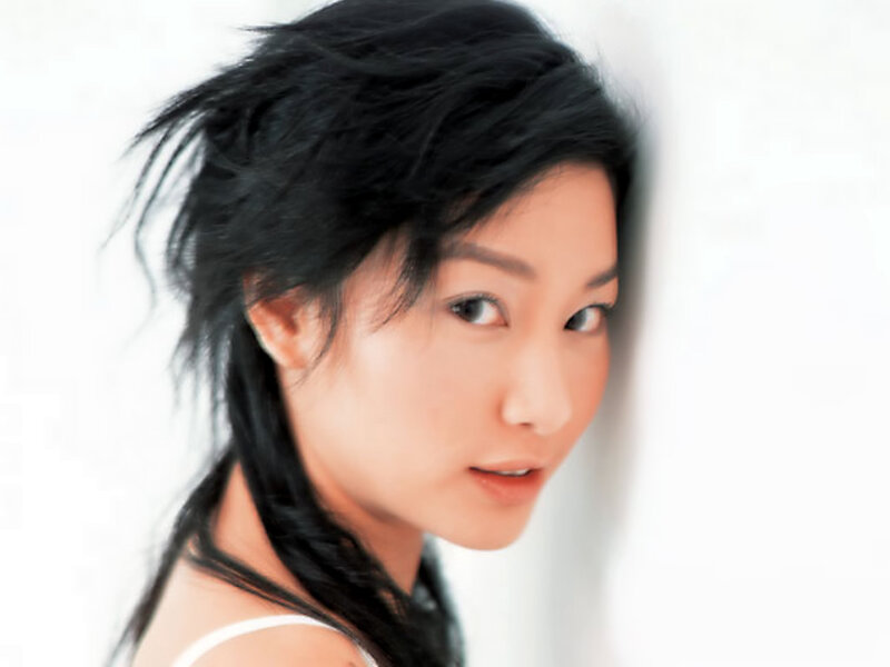 woman with dark hair looking at camera