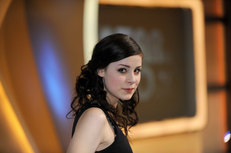 woman with dark hair looking at camera