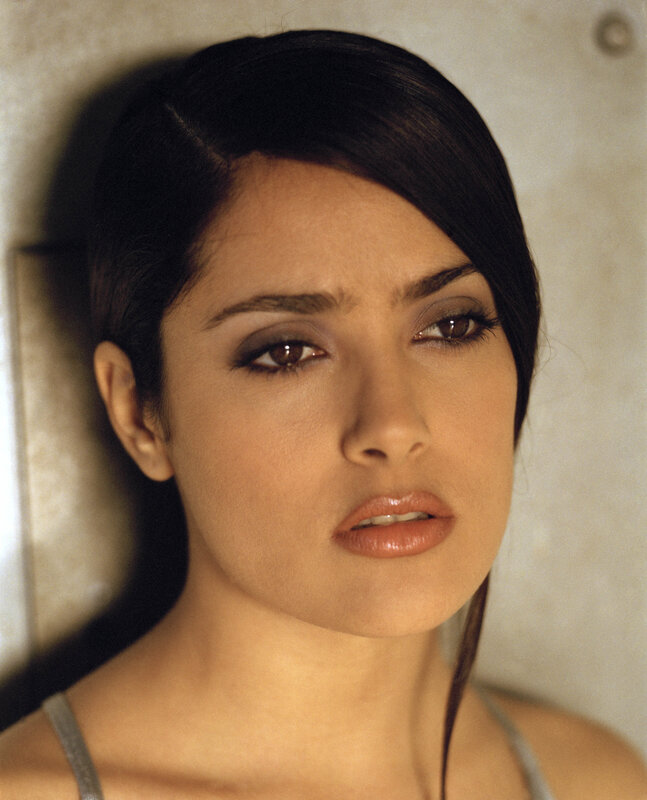 woman with dark hair looking at camera