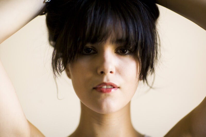 woman with dark hair looking at camera