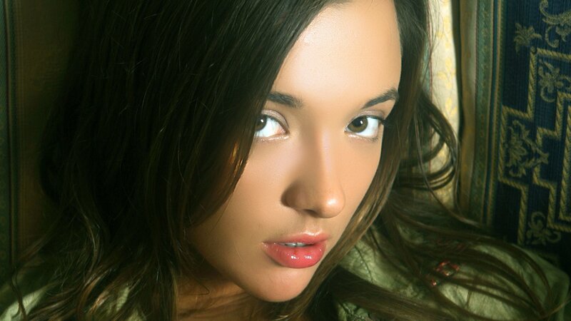 woman with dark hair looking at camera