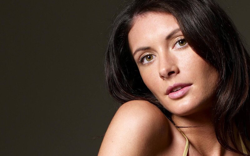 woman with dark hair looking at camera